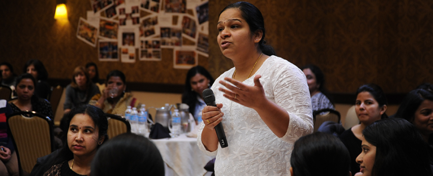 image of a woman asking a question at a business seminar